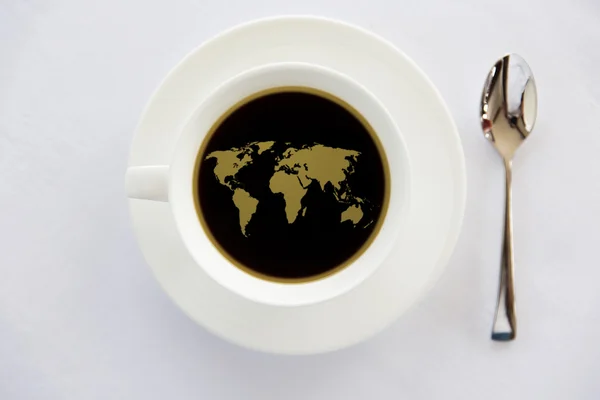 World map in cup of black coffee with spoon — Stock Photo, Image