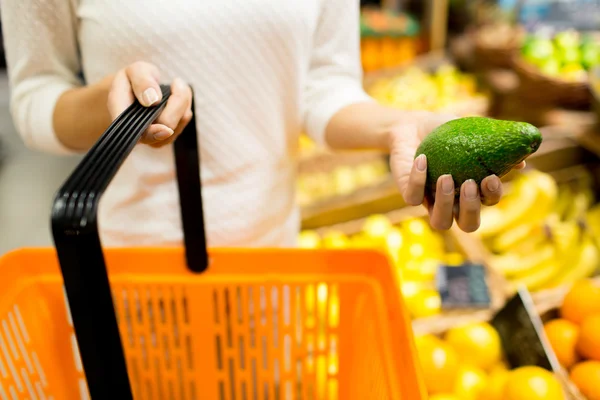 Close up of woman with food basket in market — Stock Photo, Image