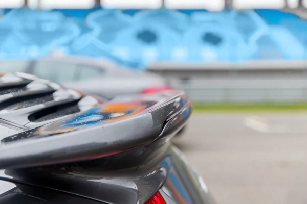 Close up of car spoiler on speedway at stadium — Stock Photo, Image