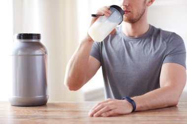 close up of man drinking protein shake clipart