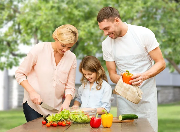 Glückliche Familie kocht Gemüsesalat zum Abendessen — Stockfoto