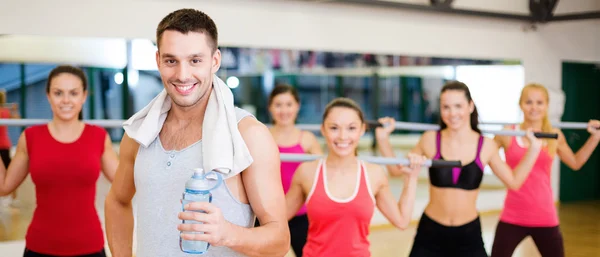 Smiling trainer in front of group of people — Stock Photo, Image
