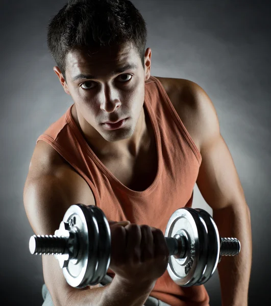 Young man with dumbbell — Stock Photo, Image