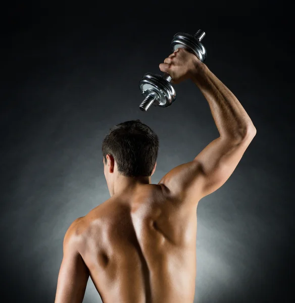 Young man with dumbbell — Stock Photo, Image