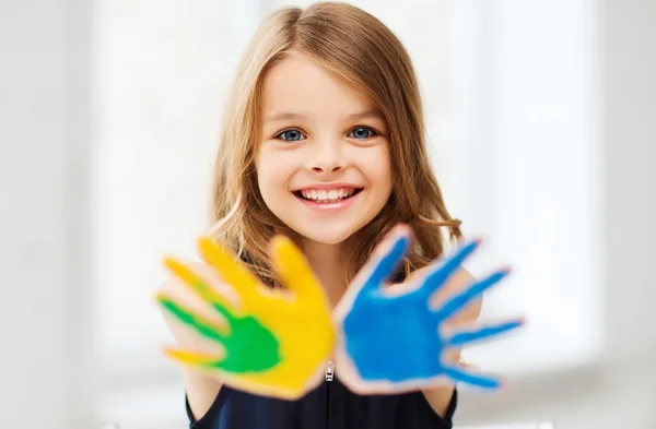 Girl showing painted hands — Stock Photo, Image