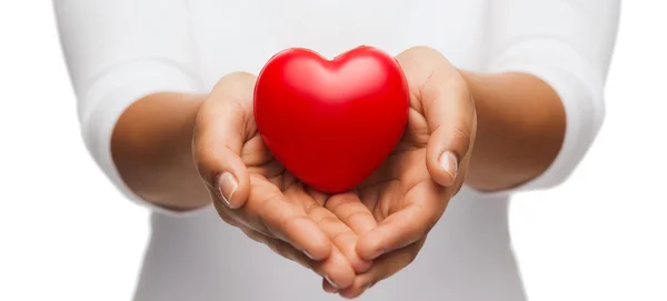 Womans cupped hands showing red heart — Stock Photo, Image