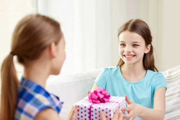 Happy little girls with birthday present at home — Stock Photo, Image