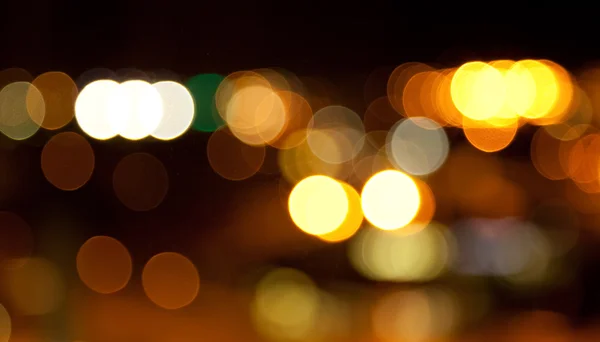Golden bright lights on dark night background — Stock Photo, Image