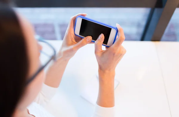 Close up of woman with smartphone at office — Stock Photo, Image