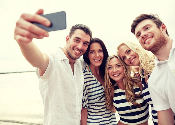 Happy friends on beach and taking selfie — Stock Photo, Image