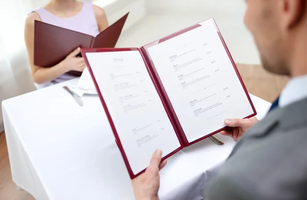 close up of couple with menu at restaurant