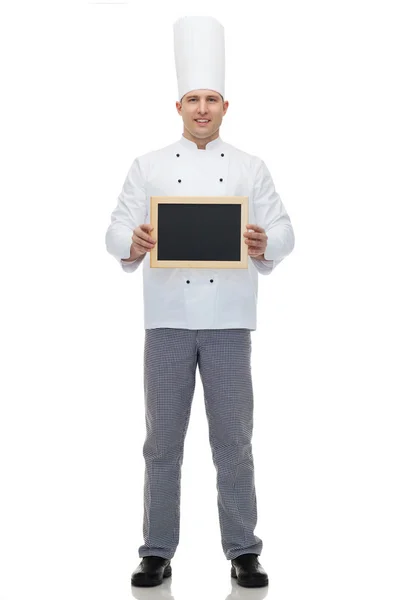 Happy male chef cook holding blank menu board — Stock Photo, Image