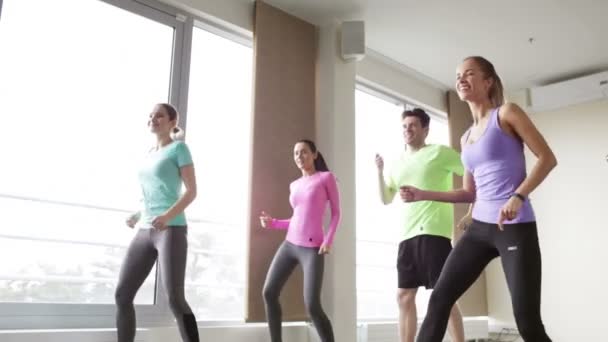 Group of smiling people dancing in gym or studio — Stock Video