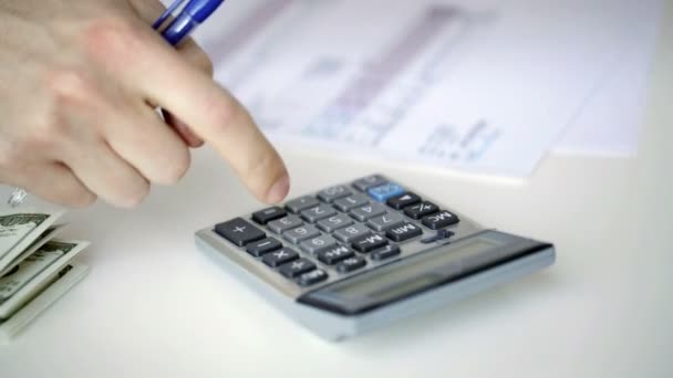 Close up of man with calculator counting money — Stock Video