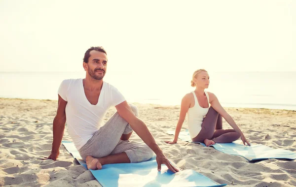 Pareja haciendo ejercicios de yoga al aire libre — Foto de Stock