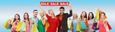happy people with red sale sign and shopping bags clipart
