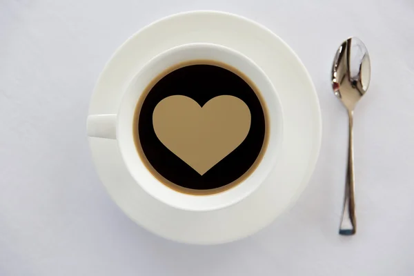 Cup of black coffee with heart shape and spoon — Stock Photo, Image