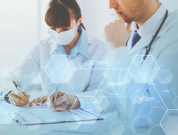 Doctor and nurse writing chemical analysis report — Stock Photo, Image