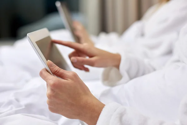 Close up of woman hands in bathrobe with tablet pc — Stock Photo, Image