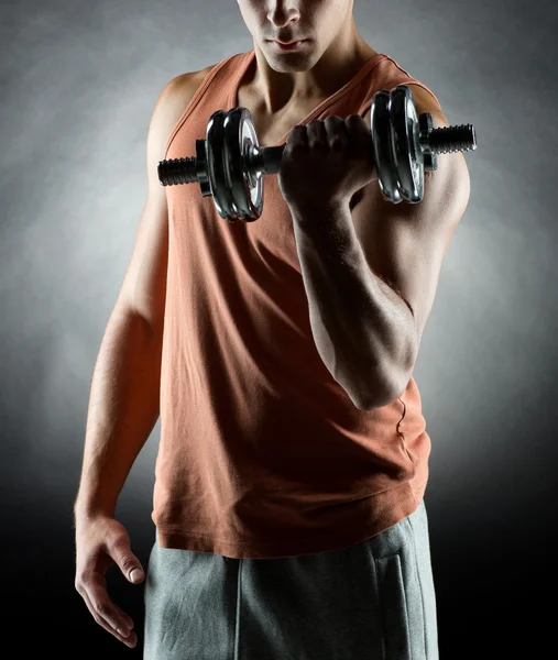 Young man with dumbbell — Stock Photo, Image