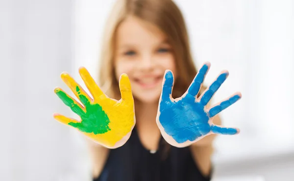 Girl showing painted hands — Stock Photo, Image