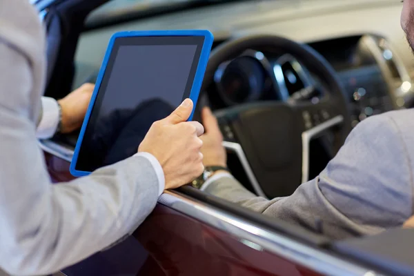 Close up of men with tablet pc in car salon — Stock Photo, Image