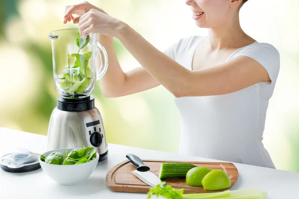 Close up of woman with blender and vegetables — Stock Photo, Image