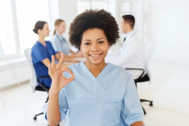 doctor or nurse showing ok hand sign at hospital clipart