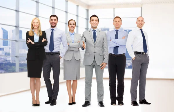 Group of smiling businessmen making handshake — Stock Photo, Image