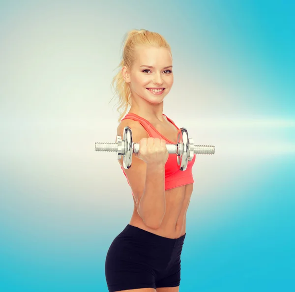 Young sporty woman with heavy steel dumbbell — Stock Photo, Image