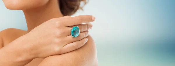 close up of woman with cocktail ring on hand