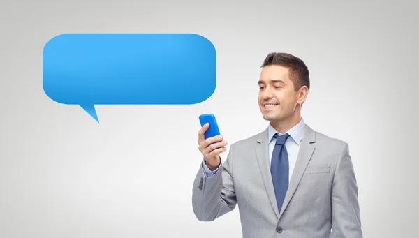 Happy businessman texting message on smartphone — Stock Photo, Image