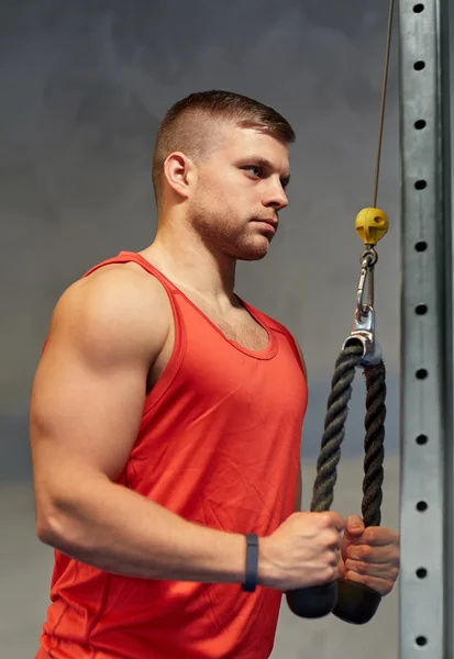 Mann lässt Muskeln an Seilzug-Turnhalle spielen — Stockfoto