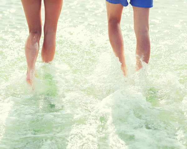 Close up of human legs on summer beach — Stock Photo, Image