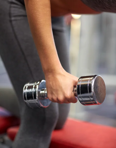 close up of couple with dumbbell exercising in gym