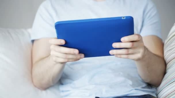 Close up of man playing game on tablet pc at home — Stock Video