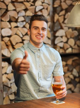 happy man with beer showing thumbs up at bar clipart
