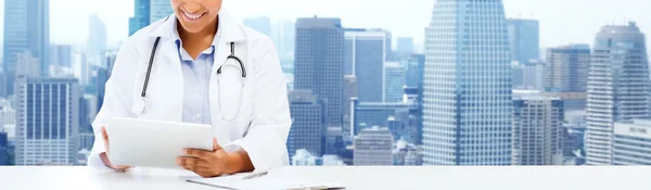 Happy african female doctor with tablet pc — Stock Fotó