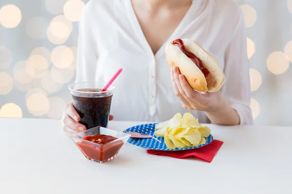 Zamknij się z kobieta jedzenie hot dog z coca cola — Zdjęcie stockowe