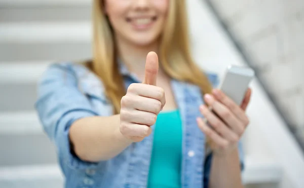 Female with smartphone showing thumbs up — 图库照片