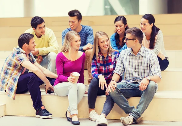 Group of smiling students with paper coffee cups — Stock Photo, Image