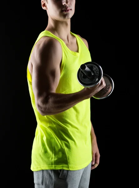 Young man with dumbbell — Stock Photo, Image