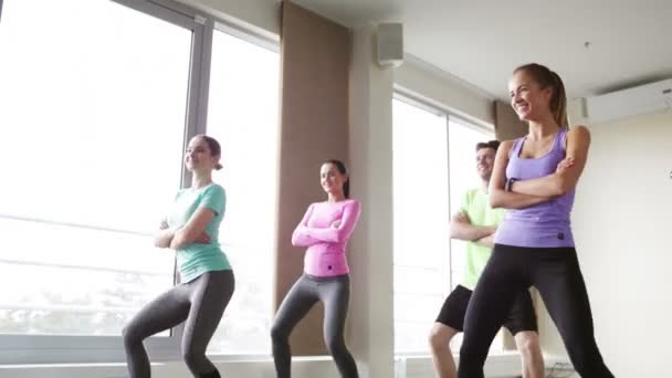 Group of smiling people dancing in gym or studio — Stock Video