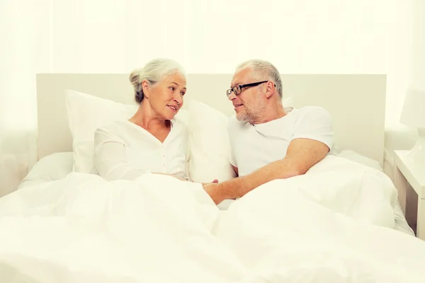 Happy senior coupler lying in bad at home — Stock Photo, Image