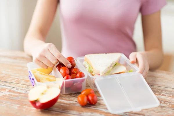Zamknij się z kobieta z jedzeniem w plastikowym pojemniku — Zdjęcie stockowe