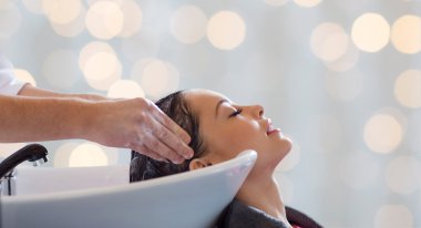 happy young woman having salon hair wash clipart