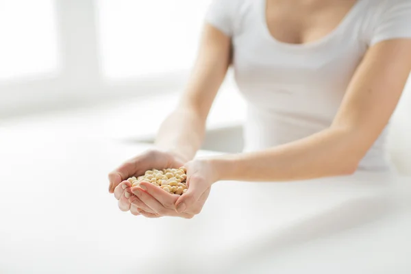 Close up of woman hands holding peeled peanuts — Stock Photo, Image