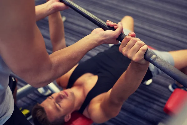 Dois homens jovens com músculos de flexão barbell no ginásio — Fotografia de Stock