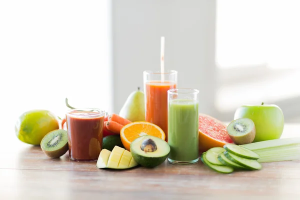 Close up of fresh juice glass and fruits on table — Stock Photo, Image