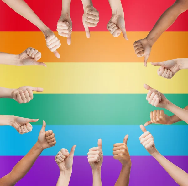 Hands showing thumbs up in circle over rainbow — Stok fotoğraf